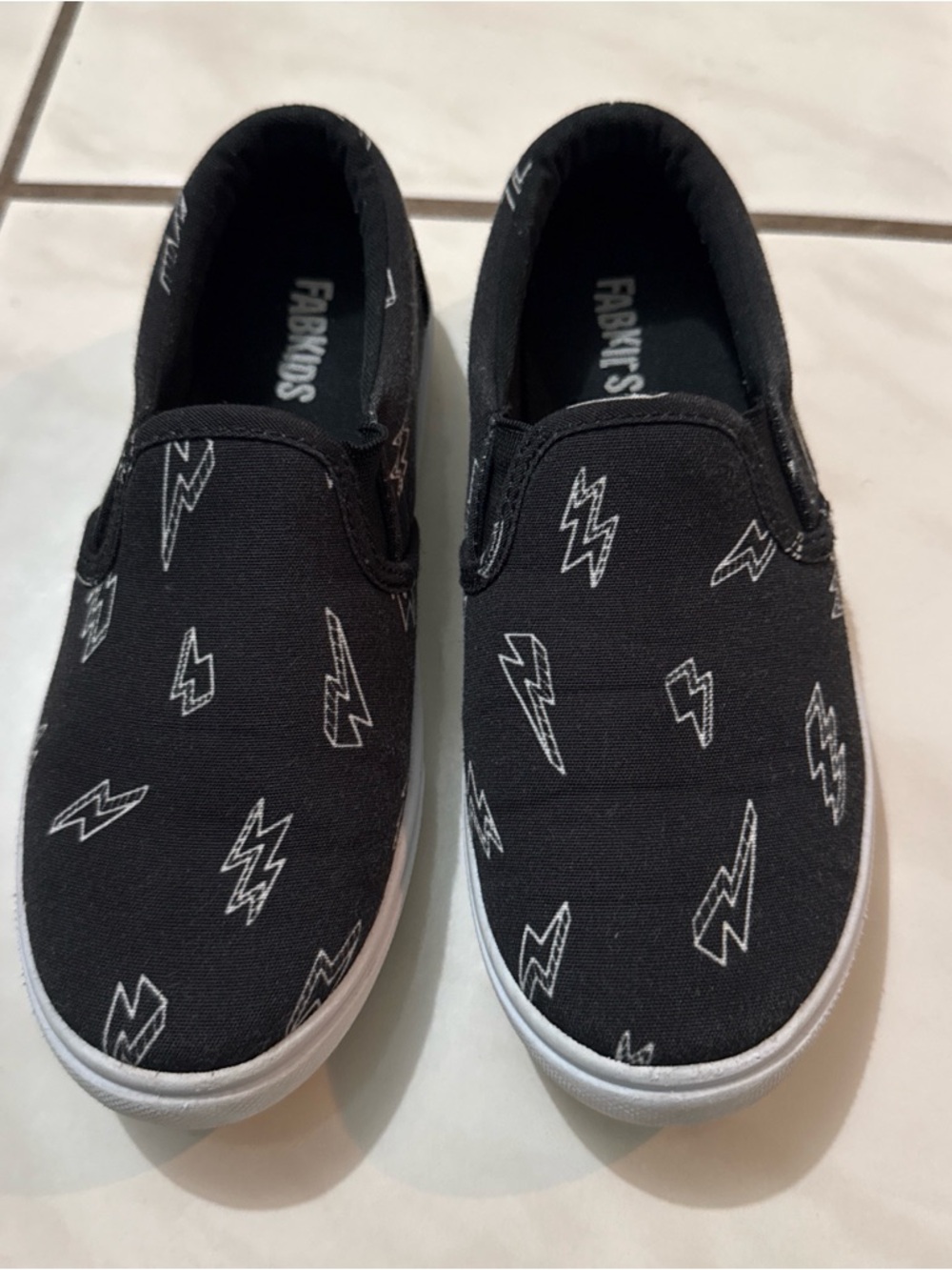 fabkids Black Slip-On Sneakers with White Lightning Print